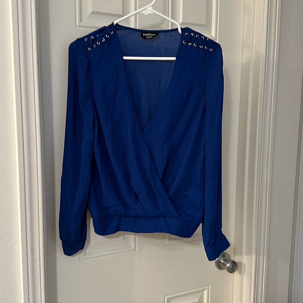 Bebe new never worn top with lace up detailing on shoulders